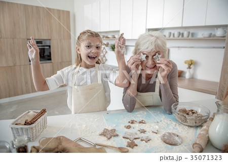 Positive family fooling around in kitchen Positive family fooling around in kitchen 35071323