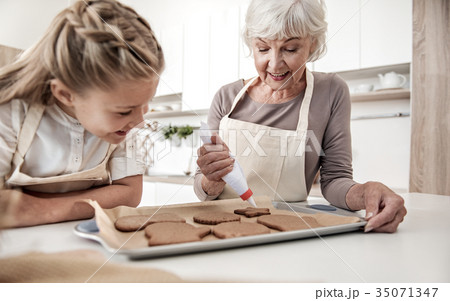 Happy grandmother squeezing cream on holiday Happy grandmother squeezing cream on holiday 35071347