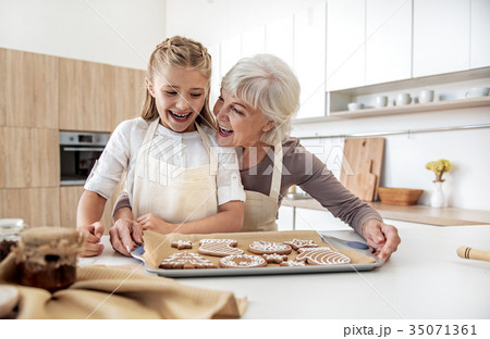 Joyful granny and child are satisfied with self Joyful granny and child are satisfied with self 35071361