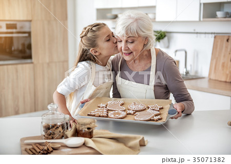 Happy child thanking grandma for sweet pastry 35071382
