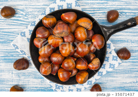 chestnuts in a pan on a wooden background 35071437