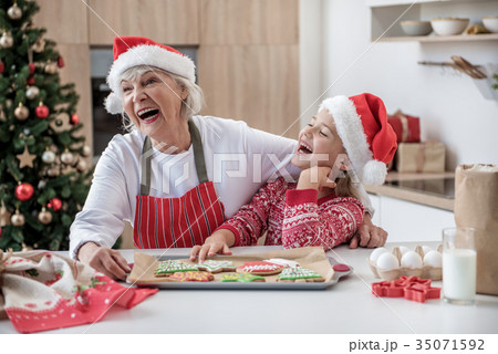 Joyful granny celebrating winter holidays with her 35071592