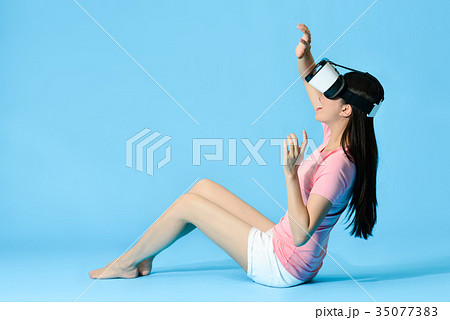 beautiful girl sitting on blue background floor beautiful girl sitting on blue background floor 35077383