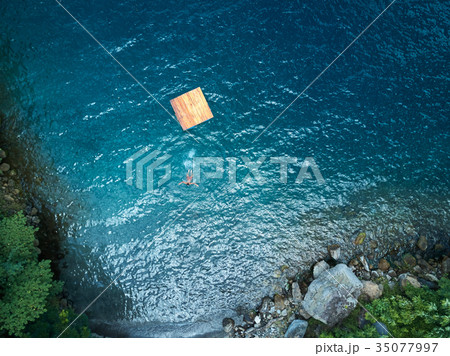 Woman swimming in blue water Woman swimming in blue water 35077997