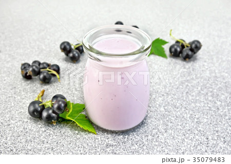 Milk cocktail with black currant on granite table 35079483