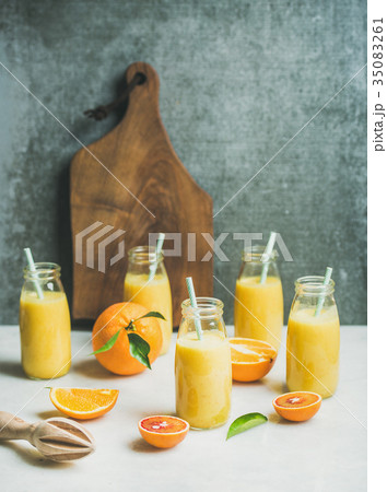 Healthy yellow smoothie with citrus fruit on light 35083261