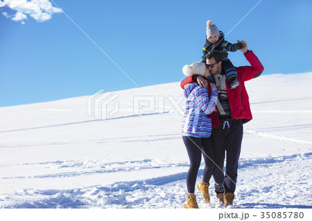 Attractive family having fun in a winter park on 35085780