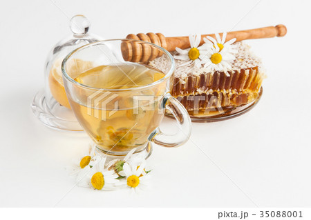 Honeycomb and chamomile tea on white 35088001