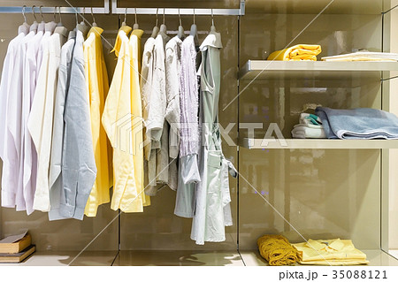 modern wooden wardrobe with clothe hanging on rail 35088121