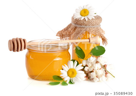 Jar of honey with flowers of acacia and chamomile 35089430