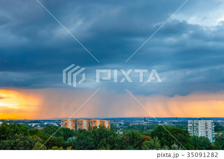 huge storm cloud with a wall of rain over the city huge storm cloud with a wall of rain over the city 35091282
