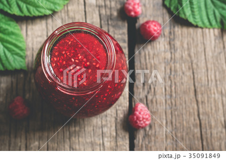 Jar with homemade raspberry jam. 35091849