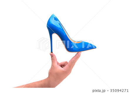 Blue lacquered female shoes in a male hand Blue lacquered female shoes in a male hand 35094271