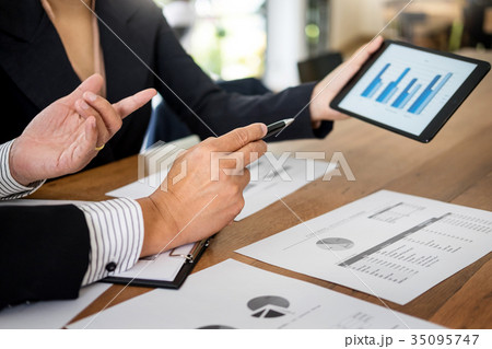 Business man and woman discuss about the financial plan on digit 35095747