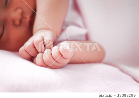 Newborn baby hand on pink blanket 35098299