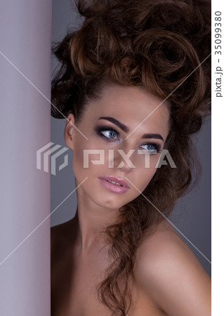 Portrait of a beautiful girl with a creative high hairstyle and 35099380