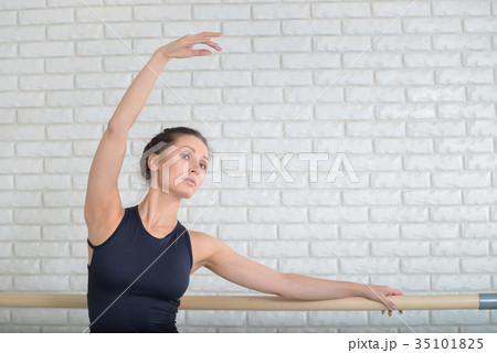 Ballerina dancing at ballet studio near barre 35101825