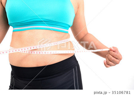 chubby  woman measuring her waistline 35106781
