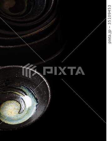 Empty bowls on black background 35109453