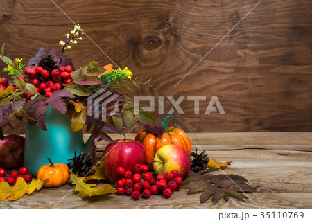 Fall table centerpiece with rowan berries in vase Fall table centerpiece with rowan berries in vase 35110769