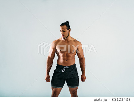 Male bodybuilder posing in studio, looking away 35123433