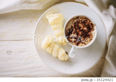 Cup of hot cocoa and cream cakes 35124421