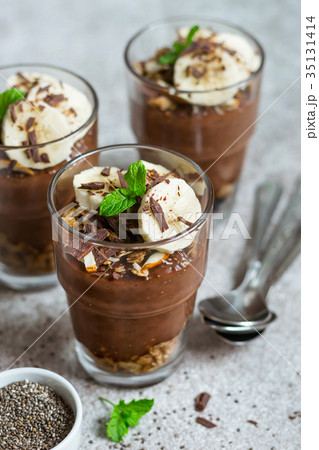 Chocolate pudding with chia and banana in glasses Chocolate pudding with chia and banana in glasses 35131414