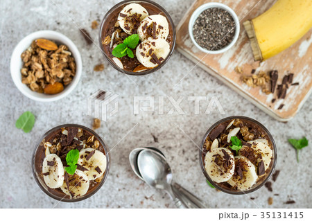 Chocolate pudding with chia and banana in glasses Chocolate pudding with chia and banana in glasses 35131415