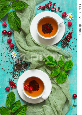 Summer tea with berries in white cups 35131443