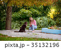 smiling girl relaxing with dog. 35132196