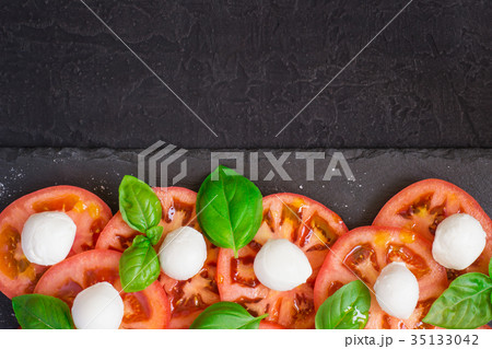 Fresh italian caprese salad  on dark plate 35133042