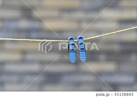 Two blue clothespins on a rope Two blue clothespins on a rope 35136693