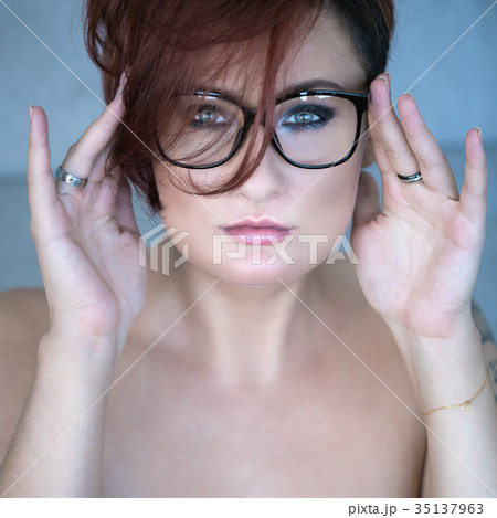 Portrait of red-haired woman in glasses Portrait of red-haired woman in glasses 35137963
