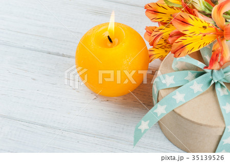 Arrangement of orange lily flowers and candle Arrangement of orange lily flowers and candle 35139526