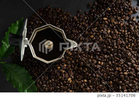 Italian coffee maker and coffee beans with leaves 35141706