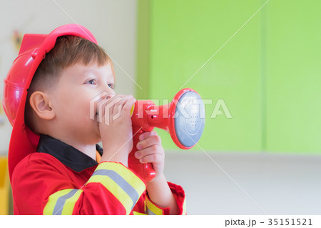 boy kid dress up to fireman and use speaker boy kid dress up to fireman and use speaker 35151521