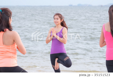 asia yoga doing tree pose and namaste at beach asia yoga doing tree pose and namaste at beach 35151523