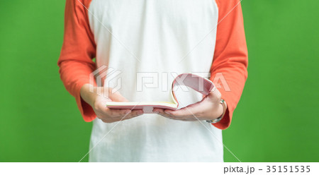 Man wear casual cloth open book at green wall Man wear casual cloth open book at green wall 35151535
