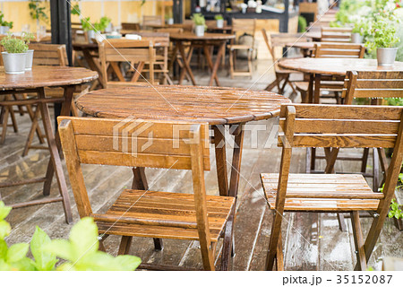 A tables and many chairs on a terrace 35152087