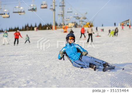 Young woman skier after the fall on mountain slope Young woman skier after the fall on mountain slope 35155464