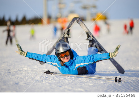 Young woman skier after the fall on mountain slope Young woman skier after the fall on mountain slope 35155469