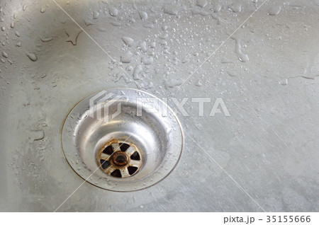 drop of water on silver stainless sink hole 35155666