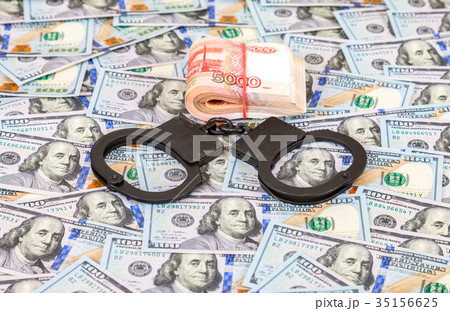 Steel police handcuffs lying on the background Steel police handcuffs lying on the background 35156625