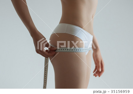 Young beautiful girl measures your body parts of Young beautiful girl measures your body parts of 35156959