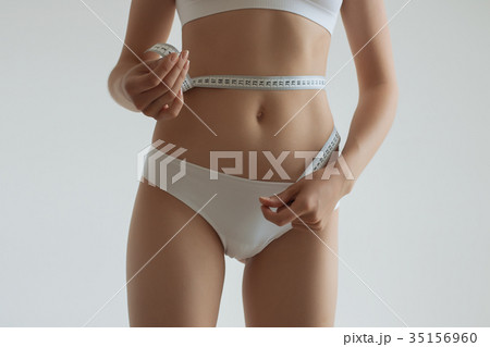 Young beautiful girl measures your body parts of Young beautiful girl measures your body parts of 35156960
