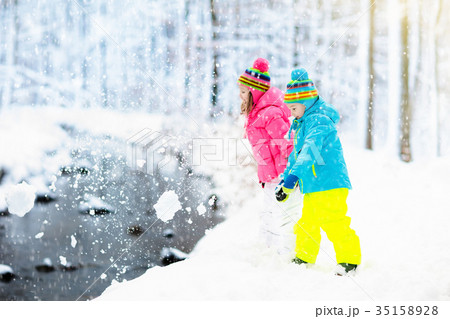 Kids playing in snow. Children play in snowfall. Kids playing in snow. Children play in snowfall. 35158928