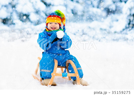 Boy on sleigh ride. Child sledding Kid with sledge Boy on sleigh ride. Child sledding Kid with sledge 35159275