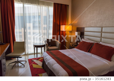 Hotel room with a prepared fresh bed Hotel room with a prepared fresh bed 35161283