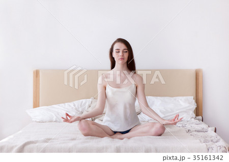 Resting yoga girl on bed concept Resting yoga girl on bed concept 35161342