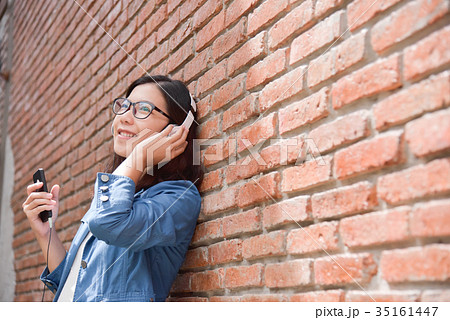 Woman listening to the music with headphone. Woman listening to the music with headphone. 35161447